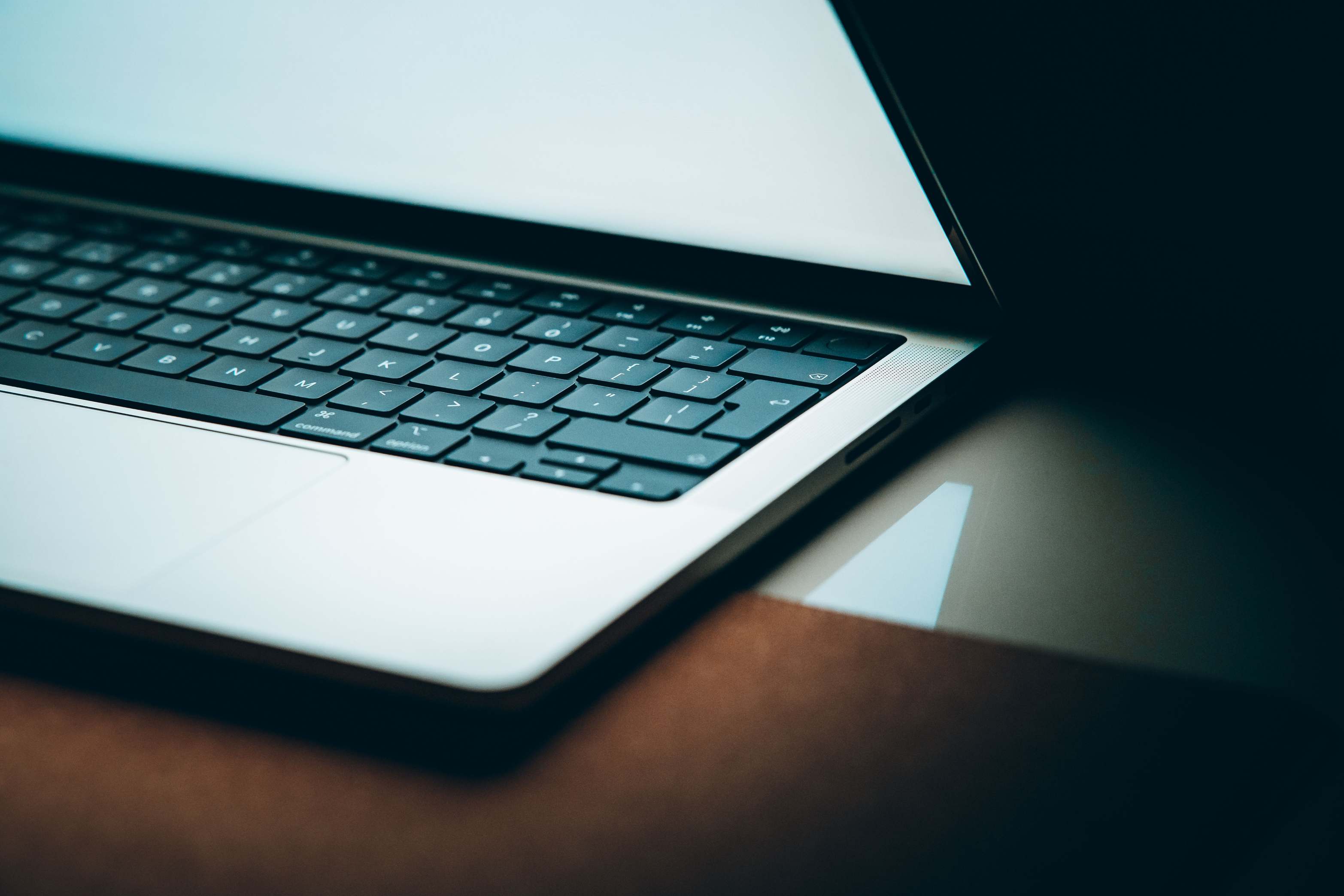 Close view of a laptop keyboard with backlit display beside the screen